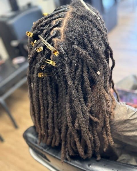 Loc palm roll with petal buns and double strand twists · Shoulder Length — before